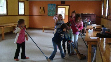 Are they sweeping the floor or playing broomball?
